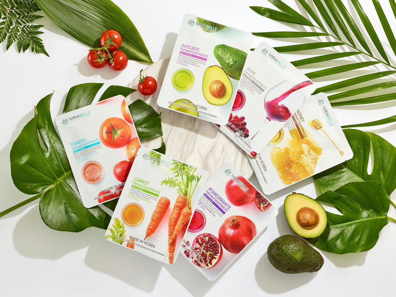 Vibrant flat lay of cosmetic face masks surrounded by fresh produce and leaves.